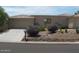 A single story home featuring a stucco exterior, a two car garage, and desert landscaping in the front yard at 14214 N Galatea Dr # A, Fountain Hills, AZ 85268