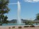Scenic view of a neighborhood lake with a beautiful water fountain and mountain views at 14214 N Galatea Dr # A, Fountain Hills, AZ 85268