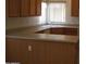 Kitchen features wooden cabinets, laminate countertops, a window with blinds, and a stainless steel sink at 14214 N Galatea Dr # A, Fountain Hills, AZ 85268