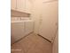 Laundry room with washer, dryer, overhead cabinets and exterior door at 14214 N Galatea Dr # A, Fountain Hills, AZ 85268