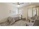 Cozy bedroom featuring a closet with mirrored doors, a ceiling fan, and neutral decor at 154 W 5Th St # 246, Tempe, AZ 85281