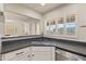 Modern kitchen with dark stone countertops, stainless steel appliances and shuttered windows at 154 W 5Th St # 246, Tempe, AZ 85281