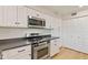 Well-lit kitchen with stainless steel appliances, white cabinetry, and dark countertops at 154 W 5Th St # 246, Tempe, AZ 85281