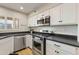 Well-lit kitchen with stainless steel appliances, white cabinetry and dark countertops at 154 W 5Th St # 246, Tempe, AZ 85281
