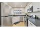 Bright kitchen with stainless steel appliances, white cabinetry, and window for natural light at 154 W 5Th St # 246, Tempe, AZ 85281