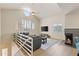 Bright living room with vaulted ceiling, modern fireplace, and large sectional sofa with a stairway at 154 W 5Th St # 246, Tempe, AZ 85281