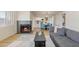 Cozy living room featuring a fireplace, gray sofa, and a dining area with blue chairs at 154 W 5Th St # 246, Tempe, AZ 85281