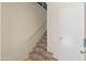 Interior staircase with carpeted steps, white walls, and a white door at 154 W 5Th St # 246, Tempe, AZ 85281