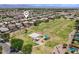 Aerial view of community park and playground featuring mature landscaping and numerous single Gathering homes at 1564 E Leaf Rd, San Tan Valley, AZ 85140