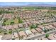 Aerial view of home featuring backyard pool, mature shade trees, rock landscaping, and desert surroundings at 1564 E Leaf Rd, San Tan Valley, AZ 85140