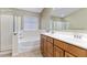 Bathroom featuring double sinks, separate shower stall and bathtub at 1564 E Leaf Rd, San Tan Valley, AZ 85140
