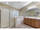 Bright bathroom with a glass-enclosed shower, soaking tub, double sink vanity, and neutral color scheme at 1564 E Leaf Rd, San Tan Valley, AZ 85140