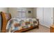 Cozy bedroom with a comfortable bed, window with blinds, and closet space at 1564 E Leaf Rd, San Tan Valley, AZ 85140