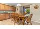 Inviting dining area with wooden table and chairs, leading to a view of the outdoor patio and backyard at 1564 E Leaf Rd, San Tan Valley, AZ 85140