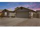 Charming single-story home featuring a two-car garage, desert landscaping, and a neutral color palette at 1564 E Leaf Rd, San Tan Valley, AZ 85140