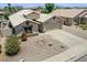 Beautiful home with a spacious driveway, well-maintained landscaping, and a charming desert rock garden at 1564 E Leaf Rd, San Tan Valley, AZ 85140