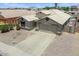Attractive home boasts desert landscaping, ample parking, desert rock garden, and an attached two-car garage at 1564 E Leaf Rd, San Tan Valley, AZ 85140