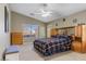 Comfortable main bedroom featuring a ceiling fan, window with blinds, and ample space for relaxation at 1564 E Leaf Rd, San Tan Valley, AZ 85140