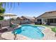 Backyard pool with a lounge chair, hot tub, and a built-in grill for outdoor entertaining and relaxation at 1564 E Leaf Rd, San Tan Valley, AZ 85140