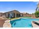 Gorgeous backyard features a pool, spa, and covered patio, perfect for relaxing or entertaining guests at 1564 E Leaf Rd, San Tan Valley, AZ 85140