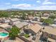 Aerial view of the property showcasing the backyard with turf, trampoline, and covered patio at 16586 W Latham St, Goodyear, AZ 85338