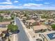 Aerial view of a home nestled in a residential neighborhood with mountain views in the distance at 16586 W Latham St, Goodyear, AZ 85338