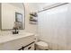 Updated bathroom featuring a white vanity, modern fixtures, and stylish decorative shelving at 16586 W Latham St, Goodyear, AZ 85338
