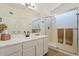 Bright bathroom with a glass-enclosed shower, a neutral vanity, and wood-look floors at 16586 W Latham St, Goodyear, AZ 85338