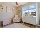 Charming Bedroom with soft pink accents, plush seating, and ample natural light at 16586 W Latham St, Goodyear, AZ 85338