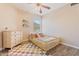 Cute room featuring a wooden toddler bed, wooden floors and a colorful rug at 16586 W Latham St, Goodyear, AZ 85338