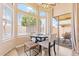 Bright breakfast nook with large windows and sliding glass door for natural lighting at 16586 W Latham St, Goodyear, AZ 85338