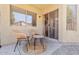 Cozy patio with two chairs, a small table, and sliding glass doors leading inside at 16586 W Latham St, Goodyear, AZ 85338