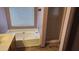 Bathroom featuring a bathtub, shower, window with blinds and sink at 17458 N 64Th Dr, Glendale, AZ 85308