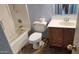 Bathroom featuring a shower-tub combo, a toilet, and vanity with sink at 17458 N 64Th Dr, Glendale, AZ 85308