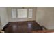 A bedroom with three windows, hardwood floors, blinds and white walls at 17458 N 64Th Dr, Glendale, AZ 85308