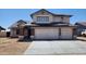 Two-story home featuring a brick garage, solar panels, and low-maintenance front yard at 17458 N 64Th Dr, Glendale, AZ 85308