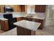 Kitchen with stainless steel appliances, wood cabinetry, and a center island at 17458 N 64Th Dr, Glendale, AZ 85308