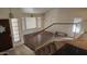 A view from the upper landing showing the living room, stairs and entry door at 17458 N 64Th Dr, Glendale, AZ 85308