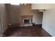 Spacious living room with wood floors, neutral walls, and a brick fireplace at 17458 N 64Th Dr, Glendale, AZ 85308