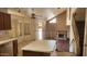 A view of the kitchen and living room showing a staircase and fireplace at 17458 N 64Th Dr, Glendale, AZ 85308