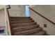 Carpeted staircase leading to the upper level with a view of the fireplace at 17458 N 64Th Dr, Glendale, AZ 85308