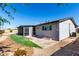 View of back of house with fenced-in yard with lawn, gravel, and small patio at 1747 W Devon --, Mesa, AZ 85201