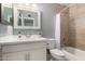 Updated bathroom features white cabinets, and a shower-tub combo at 1747 W Devon --, Mesa, AZ 85201