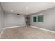 Empty room featuring neutral paint, tile floors, base trim and large windows at 1747 W Devon --, Mesa, AZ 85201