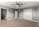 Spacious carpeted bedroom features neutral walls, a ceiling fan, and closet space at 1747 W Devon --, Mesa, AZ 85201