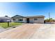Exterior view of home with a well-manicured lawn and paved driveway at 1747 W Devon --, Mesa, AZ 85201