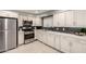 Beautiful kitchen featuring stainless steel appliances, white cabinets, and tile floors at 1747 W Devon --, Mesa, AZ 85201