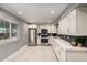 Bright kitchen featuring stainless steel appliances, white cabinets, and stone countertops at 1747 W Devon --, Mesa, AZ 85201