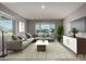 Staged living room with a large sofa, area rug, windows and neutral walls at 1747 W Devon --, Mesa, AZ 85201