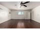 Open living room with dark floors, bright walls, ceiling fan, and good natural lighting at 1747 W Devon --, Mesa, AZ 85201